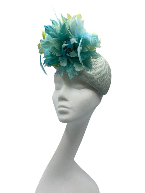 Pale green teardrop base headpiece with an array of stunning complementary feathers to finish.